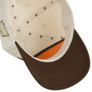 Close-up of a cap with brown brim and white top on a white background