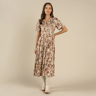 Woman wearing a floral dress on a beige background