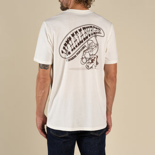 Person wearing a white t-shirt with a graphic design on the back against a beige background