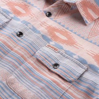 Close-up of a patterned shirt with a brand label on a light background