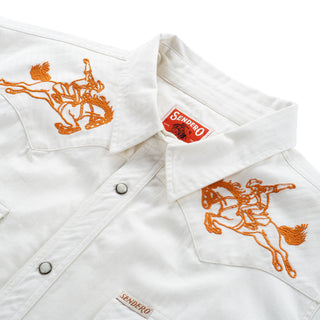 White jacket with orange embroidered designs and Sendero logo on a white background