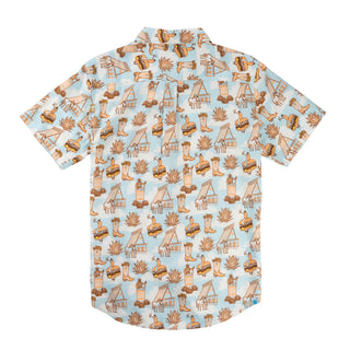 Short-sleeve shirt with a pattern of boots, houses, and other elements on a light blue background