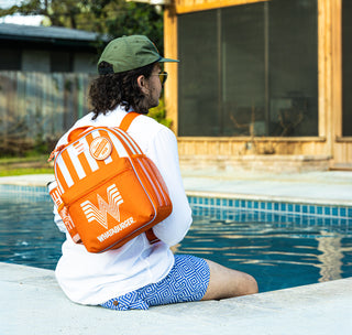 view igloo x whataburger backpack on model next to pool.