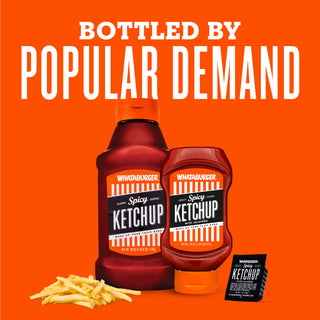 Two bottles of Spicy Ketchup with fries and a packet on an orange background, labeled 'Bottled by Popular Demand'.