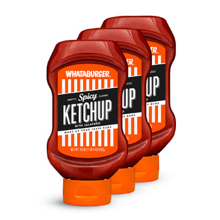 Three bottles of Whataburger Spicy Ketchup on a white background