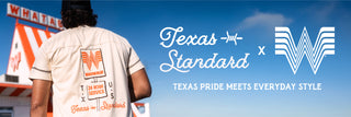 Person wearing a branded t-shirt with 'Texas Standard' logo against a blue sky.