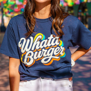 Person wearing a blue t-shirt with 'Whataburger' text in colorful script letters.