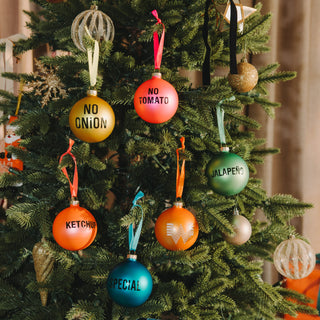 Decorative Day Dot tree ornaments with text on a green tree.
