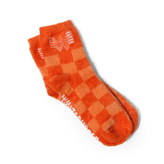 Orange checkered socks with a brand logo on a white background