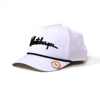 A white golf hat with black "Whataburger" script embroidery on the front and a black rope detail along the brim. The Flying W Golf Hat Clip is attached to the hat's brim, showcasing its orange and white enamel design.