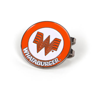 A detailed image of the Flying W Golf Hat Clip, showing its round metal design with the Whataburger "Flying W" logo at the center. The enamel features a bright orange border with white text spelling "WHAT A BURGER," and the clip is designed to attach securely to a hat brim.