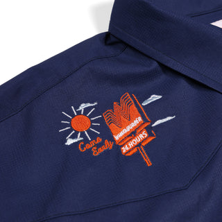Navy blue shirt with orange and white embroidered design on a white background