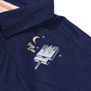Navy blue shirt with embroidered design on a white background