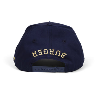 Navy blue cap with 'Burger' embroidered in gold on a white background