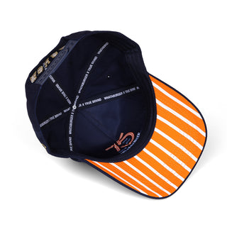 Navy blue cap with orange and white striped brim on a white background