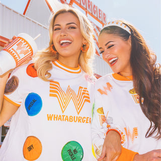 Two women wearing Brianna Cannon x Whataburger shirts with colorful graphics and text.