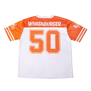 A white and orange football jersey laid flat on a white background, with 'WHATABURGER' across the chest and the number '50' in large orange block letters. The sleeves have white stripes.