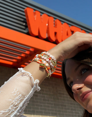 View woman outside of Whataburger restaurant wearing Whataburger Erimish Bracelet Stack